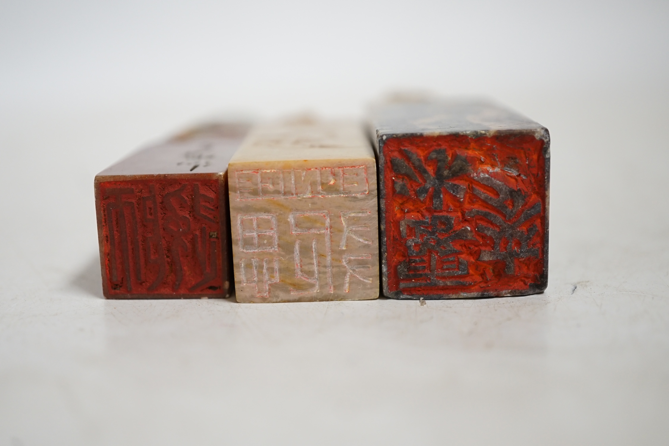 Three Chinese carved soapstone seals and a 'peach' cup, largest 12.5cm wide. Condition - fair to good